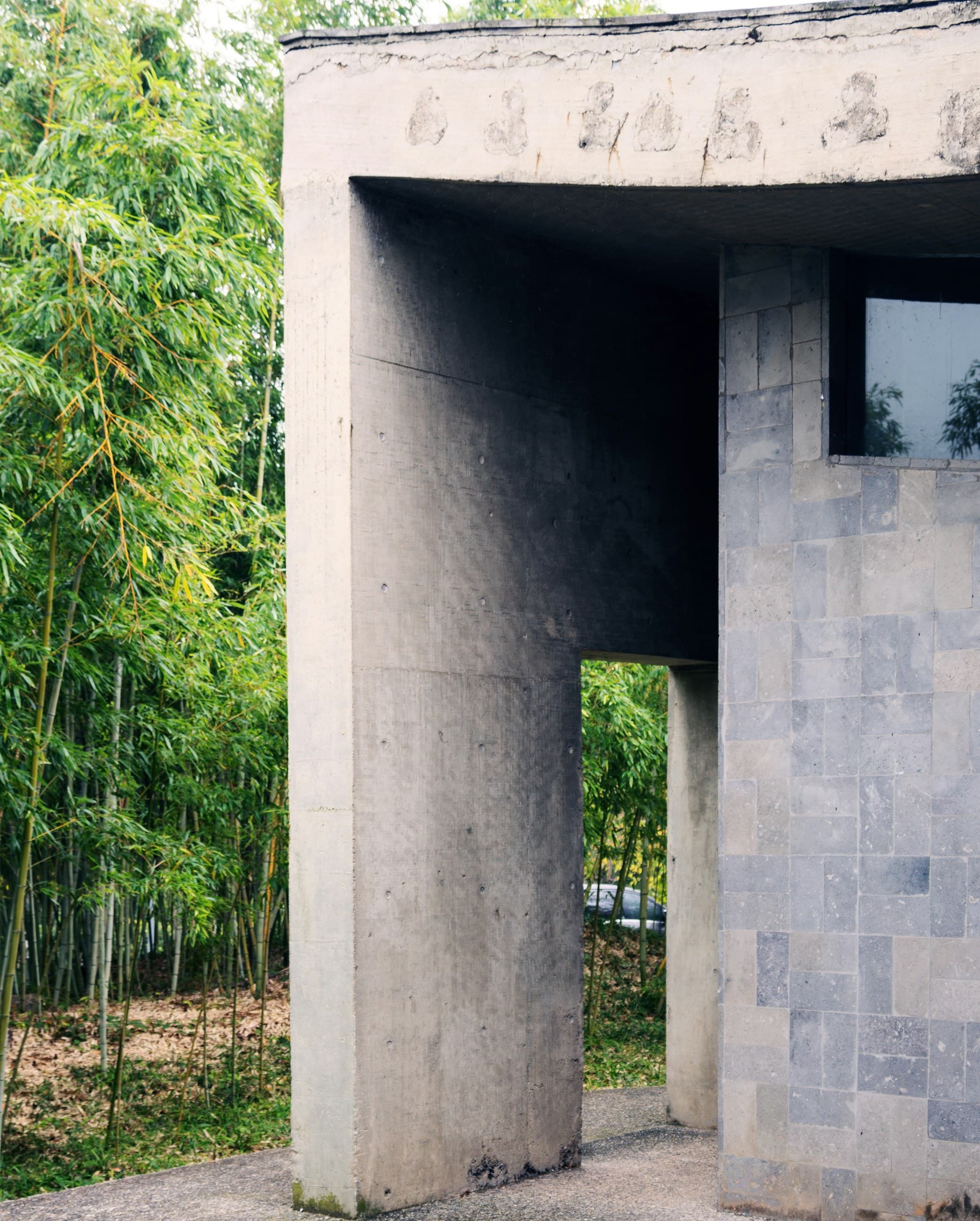 A concrete structure with a window in the middle of it