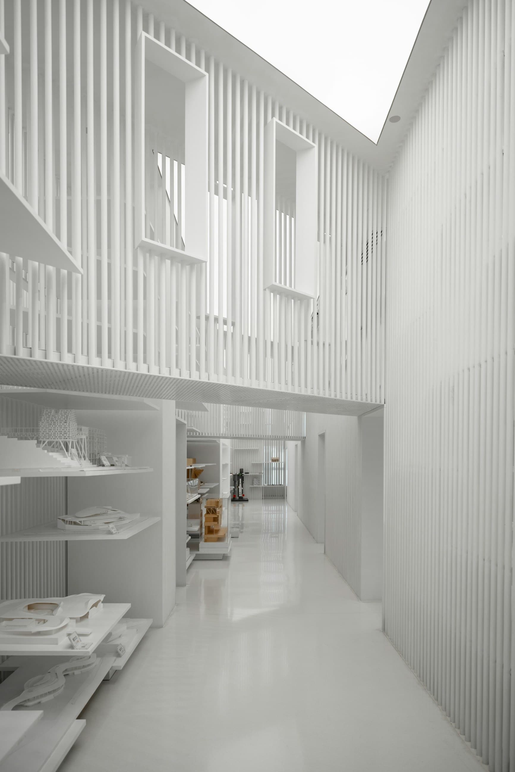 a long white hallway with a skylight above it