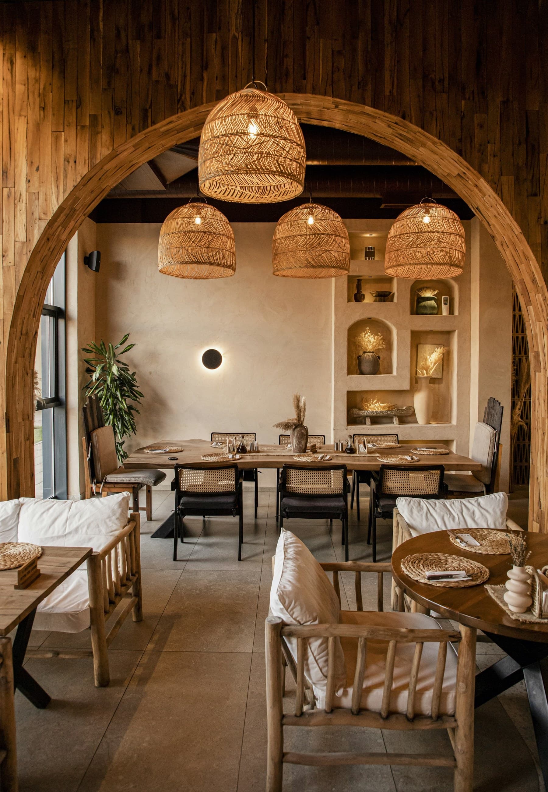 Warm, inviting dining area with natural wood and woven pendant lights